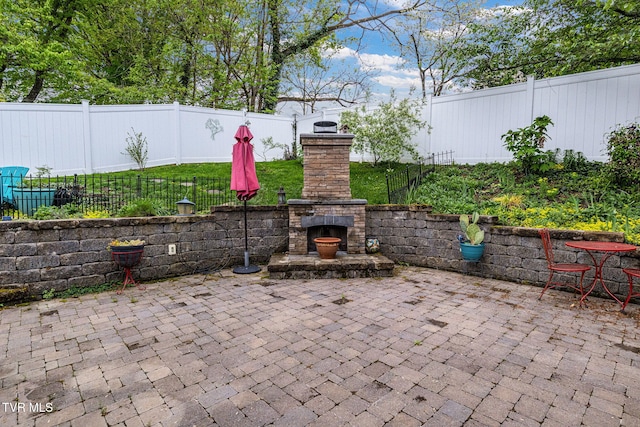 300 SW Grove Terrace Dr, Abingdon, VA 24210 - view of patio featuring an outdoor stone fireplace and a fenced backyard