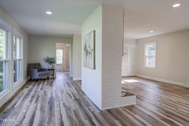 corridor with baseboards, recessed lighting, and wood finished floors