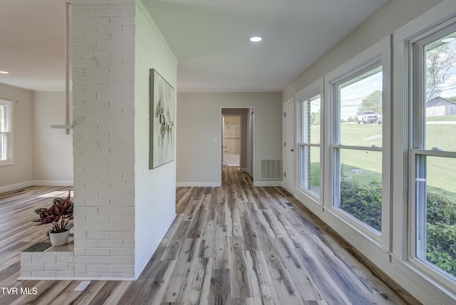 hall featuring recessed lighting, baseboards, light wood-type flooring, and visible vents