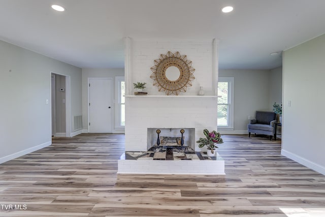 living room with baseboards, recessed lighting, wood finished floors, and visible vents