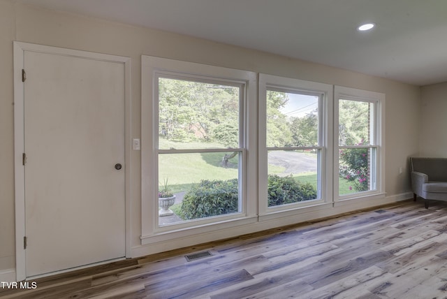 doorway featuring a healthy amount of sunlight, recessed lighting, wood finished floors, and visible vents