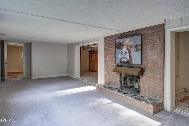 unfurnished living room featuring a textured ceiling, baseboards, carpet, and a fireplace