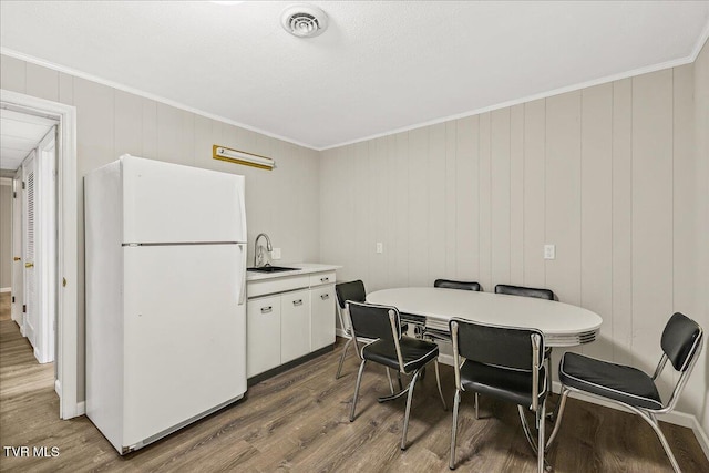1837 Presswood Rd Unit 1837, Johnson City, TN 37604 - kitchen with freestanding refrigerator, a sink, wood finished floors, and white cabinetry