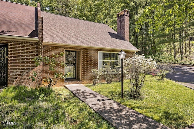 1837 Presswood Rd Unit 1837, Johnson City, TN 37604 - view of front of house featuring roof with shingles, a chimney, a front lawn, and brick siding