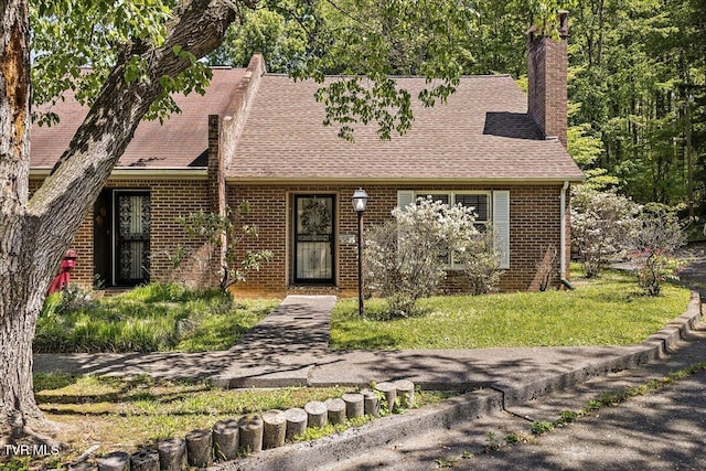 1837 Presswood Rd Unit 1837, Johnson City, TN 37604 - tudor house featuring brick siding, a front yard, a chimney, and roof with shingles
