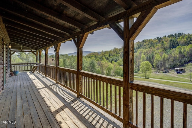 wooden terrace with a wooded view