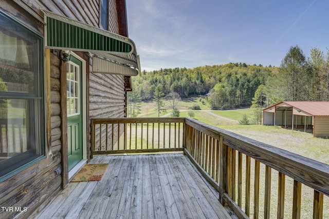 wooden deck with a view of trees