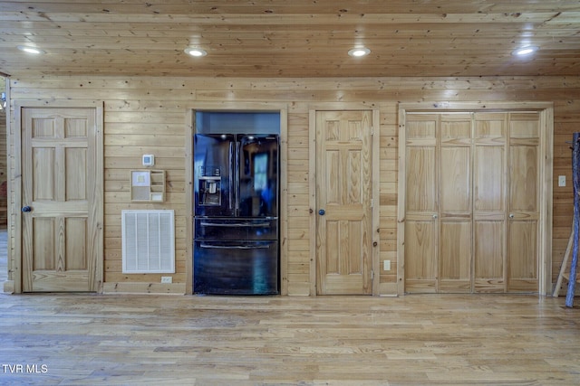 interior space with wood walls, recessed lighting, wooden ceiling, wood finished floors, and visible vents