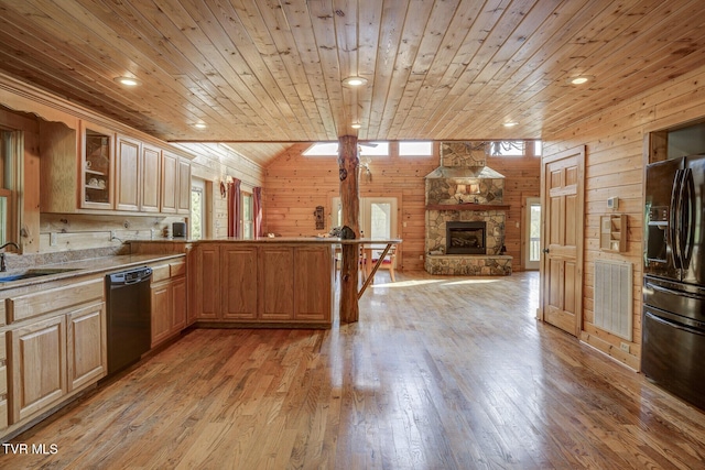 kitchen with a sink, wood ceiling, black appliances, and a healthy amount of sunlight