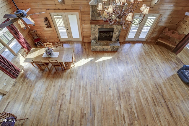 living area with a chandelier, plenty of natural light, french doors, and hardwood / wood-style flooring