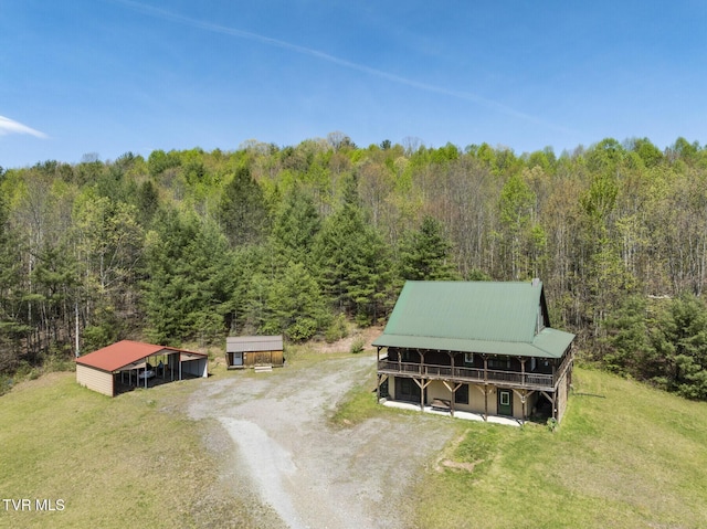 drone / aerial view featuring a wooded view