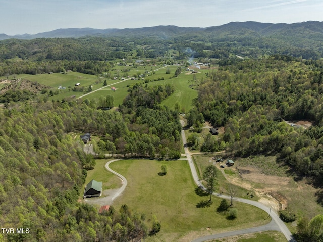 drone / aerial view with a mountain view and a forest view