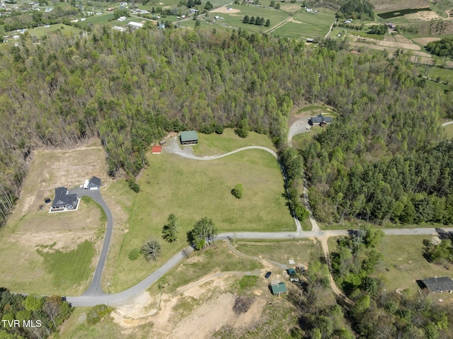 drone / aerial view featuring a rural view and a wooded view