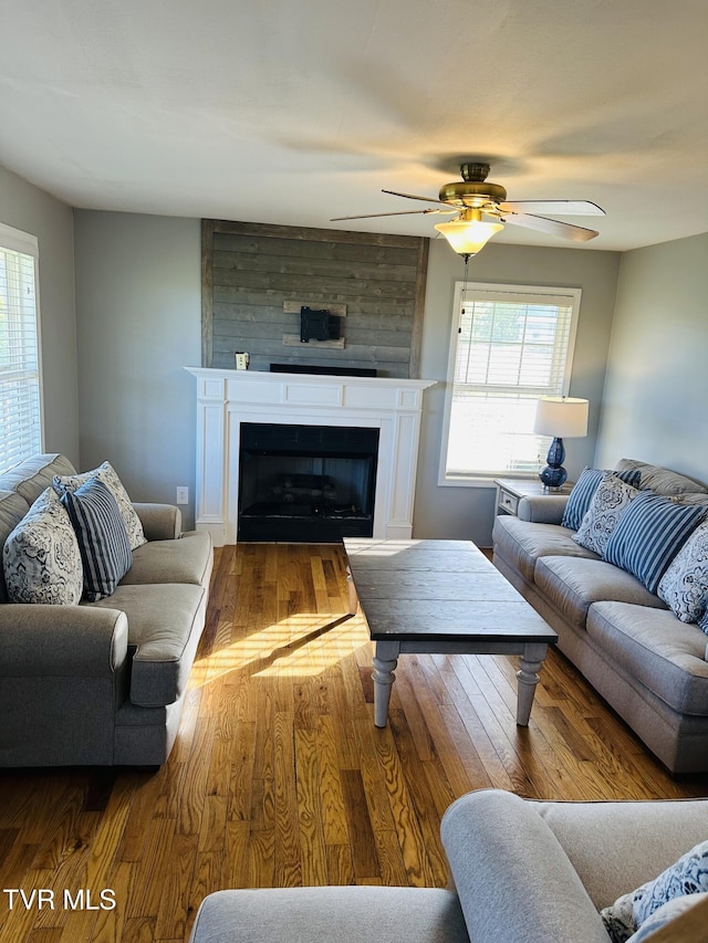 84 Deerview Ln, Lebanon, VA 24266 - living room with a ceiling fan, a healthy amount of sunlight, wood finished floors, and a fireplace