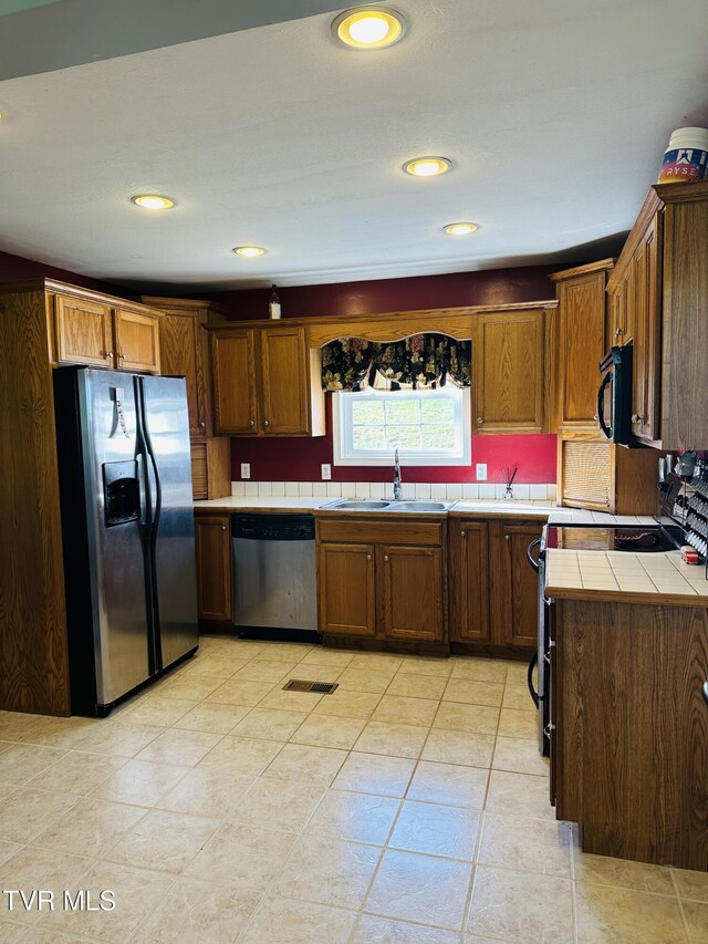 84 Deerview Ln, Lebanon, VA 24266 - kitchen featuring a sink, tile counters, light tile patterned floors, visible vents, and black appliances