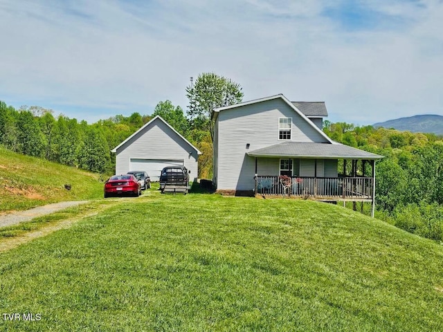 84 Deerview Ln, Lebanon, VA 24266 - exterior space featuring a lawn, a shingled roof, an outdoor structure, and a garage