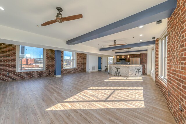 200 E Main St Unit 5, Johnson City, TN 37604 - unfurnished living room featuring light wood-style floors, ceiling fan, and brick wall