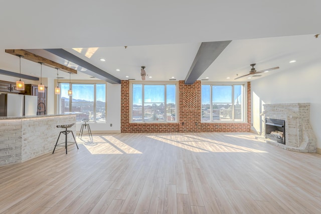 200 E Main St Unit 5, Johnson City, TN 37604 - unfurnished living room featuring light wood-style floors, plenty of natural light, and beamed ceiling