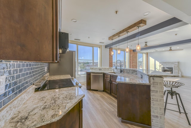 200 E Main St Unit 5, Johnson City, TN 37604 - kitchen with ceiling fan, a sink, a kitchen breakfast bar, a stone fireplace, and stainless steel appliances