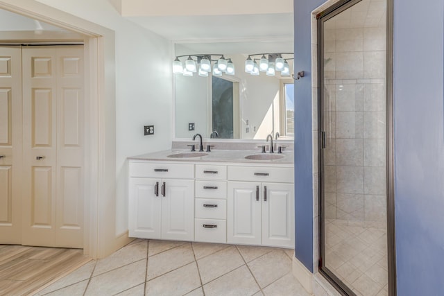 200 E Main St Unit 5, Johnson City, TN 37604 - full bathroom with double vanity, a shower stall, a sink, and tile patterned flooring