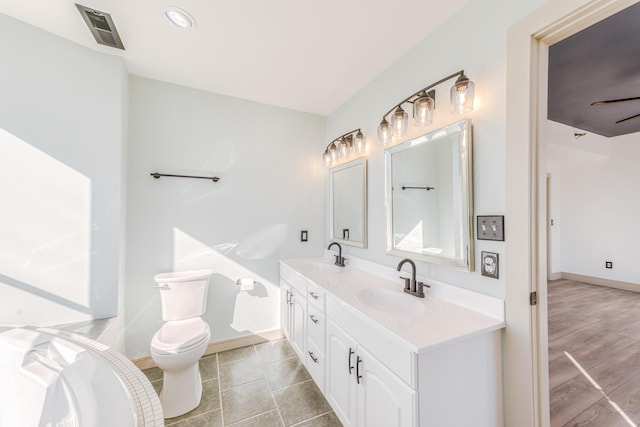 200 E Main St Unit 5, Johnson City, TN 37604 - bathroom with double vanity, toilet, visible vents, and a sink