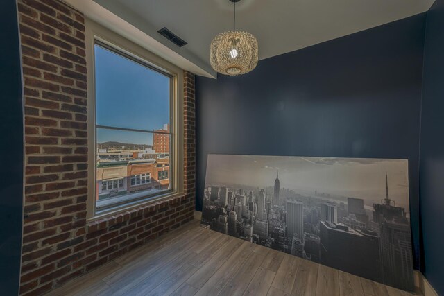 200 E Main St Unit 5, Johnson City, TN 37604 - empty room with a city view, visible vents, and wood finished floors