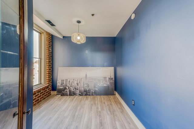 200 E Main St Unit 5, Johnson City, TN 37604 - empty room featuring baseboards, a healthy amount of sunlight, and wood finished floors