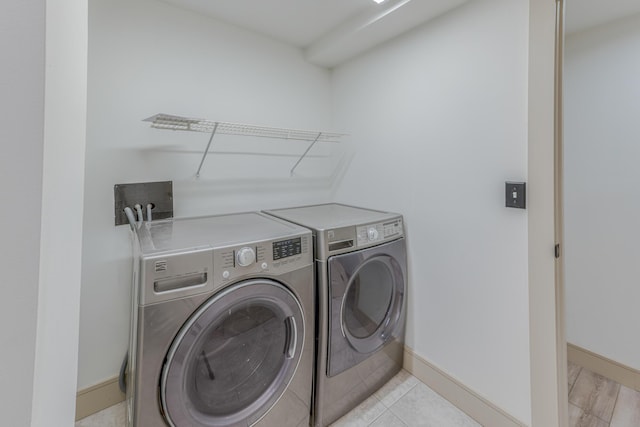 200 E Main St Unit 5, Johnson City, TN 37604 - washroom featuring baseboards, laundry area, and washer and clothes dryer