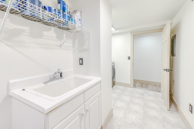 200 E Main St Unit 5, Johnson City, TN 37604 - laundry area with laundry area, washer / dryer, baseboards, a sink, and light tile patterned floors