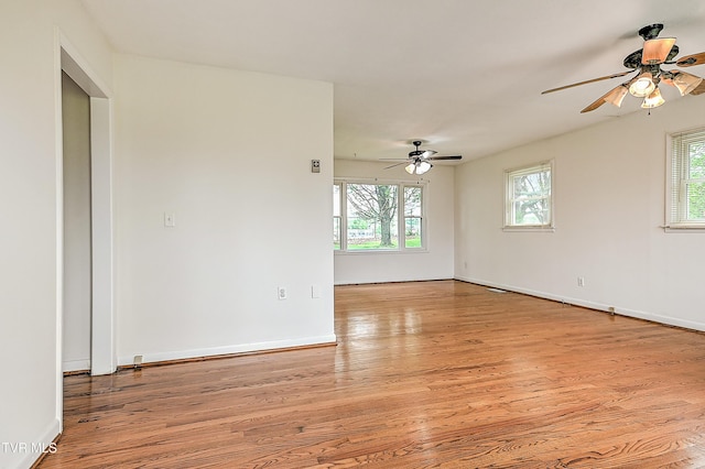 unfurnished room with ceiling fan, plenty of natural light, and light wood-style floors