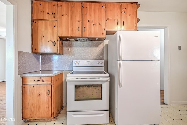 kitchen featuring white appliances, light countertops, extractor fan, decorative backsplash, and light floors