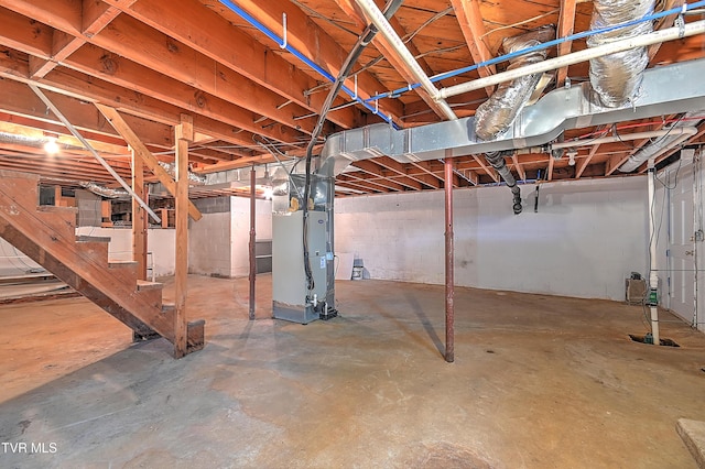 unfinished basement with heating unit and stairs