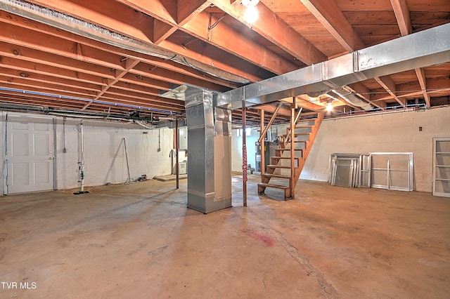 unfinished basement featuring stairs