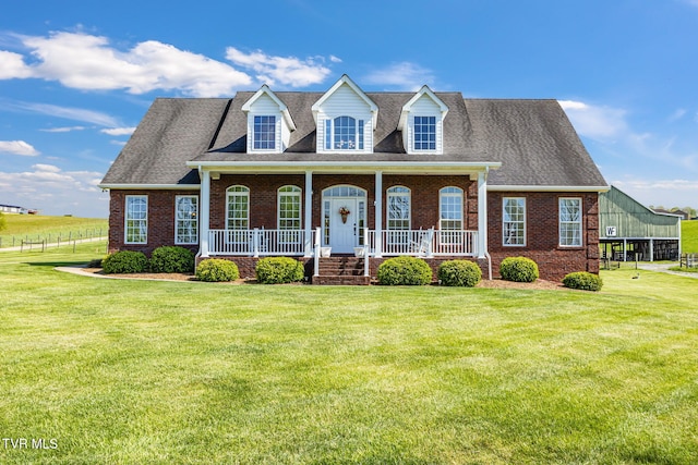 963 Beaver Creek Rd, Bluff City, TN 37618 - new england style home featuring a porch, a front lawn, and brick siding