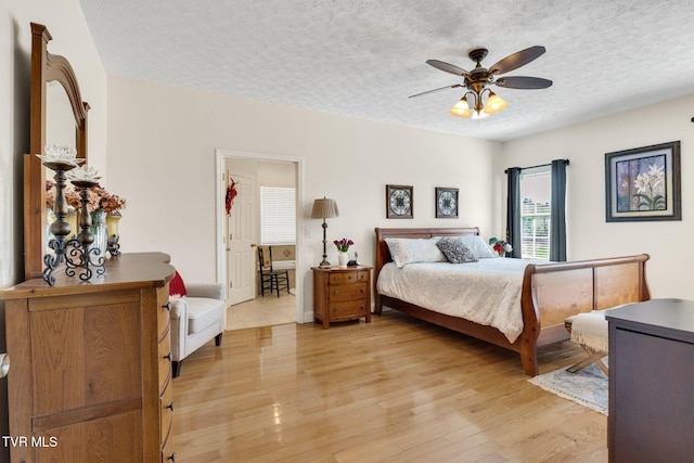 963 Beaver Creek Rd, Bluff City, TN 37618 - bedroom with a textured ceiling, light wood finished floors, and ceiling fan