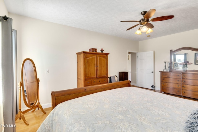 963 Beaver Creek Rd, Bluff City, TN 37618 - bedroom with light wood-type flooring, a ceiling fan, baseboards, and a textured ceiling