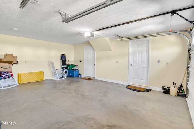 963 Beaver Creek Rd, Bluff City, TN 37618 - garage featuring baseboards and a garage door opener