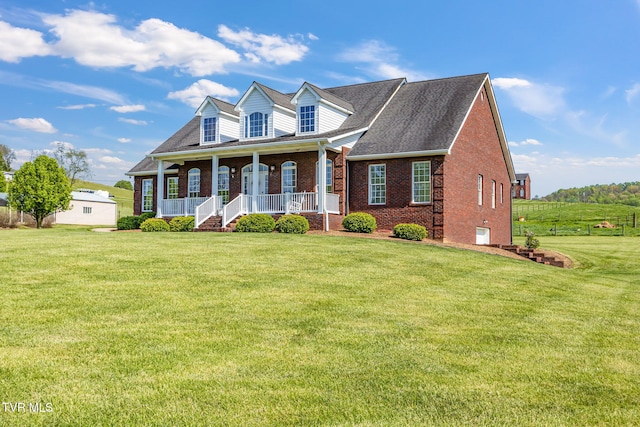 963 Beaver Creek Rd, Bluff City, TN 37618 - new england style home featuring covered porch, a front yard, and brick siding