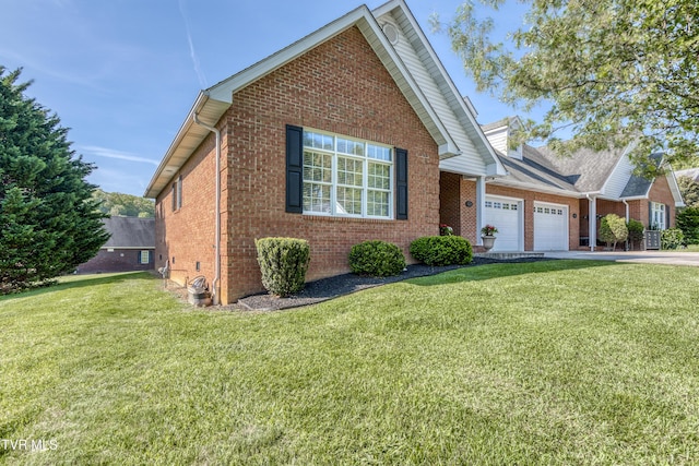 view of front of home with brick siding, a garage, a front lawn, and concrete driveway