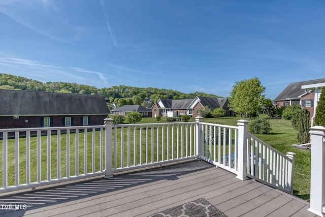 deck featuring a residential view and a lawn