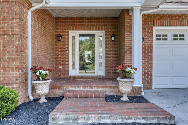 property entrance featuring brick siding and a garage