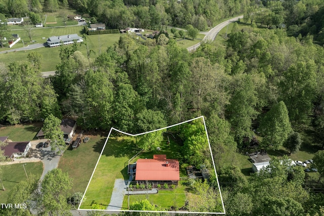 drone / aerial view featuring a forest view