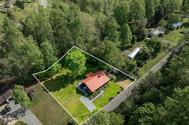 birds eye view of property featuring a view of trees