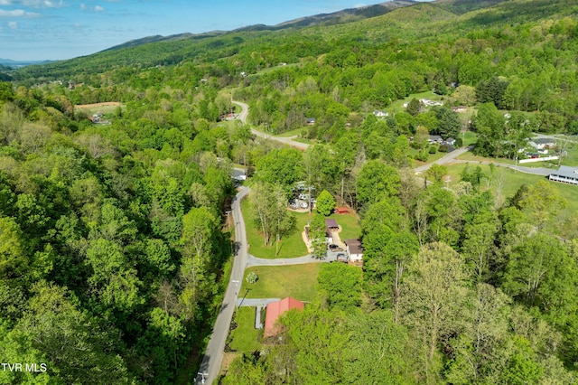 drone / aerial view featuring a view of trees and a mountain view