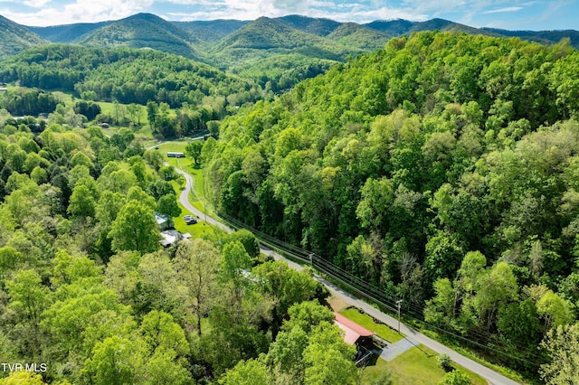 aerial view with a wooded view and a mountain view