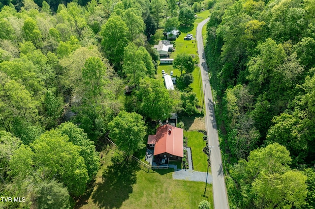 birds eye view of property with a view of trees