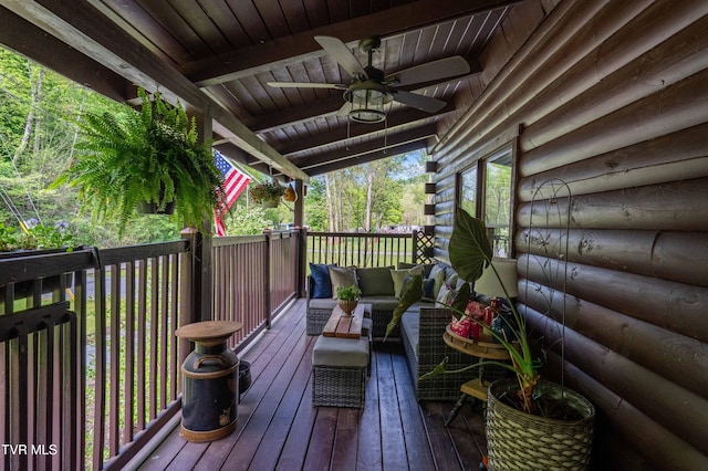 wooden deck featuring ceiling fan and an outdoor living space
