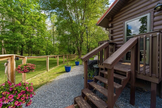 view of yard with stairway and a deck