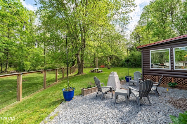 view of patio / terrace featuring an outdoor fire pit and fence