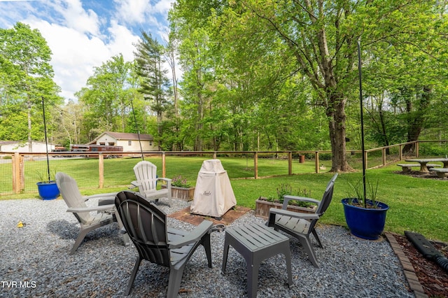 view of patio / terrace with fence and an outdoor fire pit